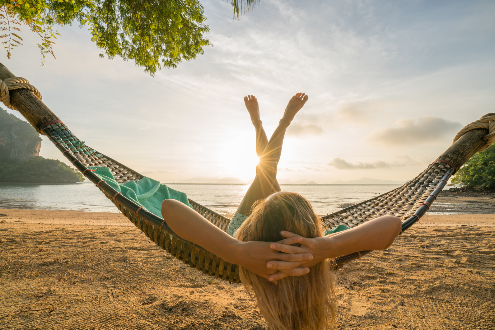 Dream life, female relaxing in hammock on tropical beach